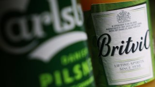 A can of Carlsberg AS pilsner and a Britvic Plc apple drink arranged in London, UK, on Friday, June 21, 2024.