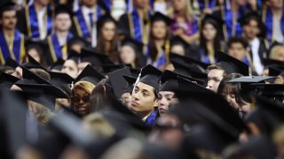 Graduates listen as actor Sean Astin delivers the keynote speech during the commencement ceremony for the College of Arts and Sciences at UCLA’s Pauley Pavilion on June 14, 2024.