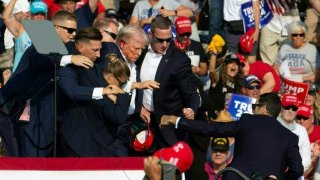 Republican candidate Donald Trump is seen with blood on his face surrounded by secret service agents as he is taken off the stage at a campaign event at Butler Farm Show Inc. in Butler, Pennsylvania, July 13, 2024. 