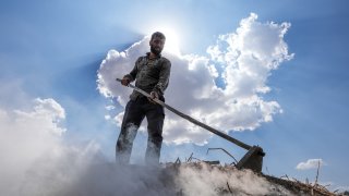 A worker, called ‘torchers’, works in a charcoal production during scorching heat exceeding 40 degrees Celsius in Diyarbakir, Turkiye on July 18, 2024.