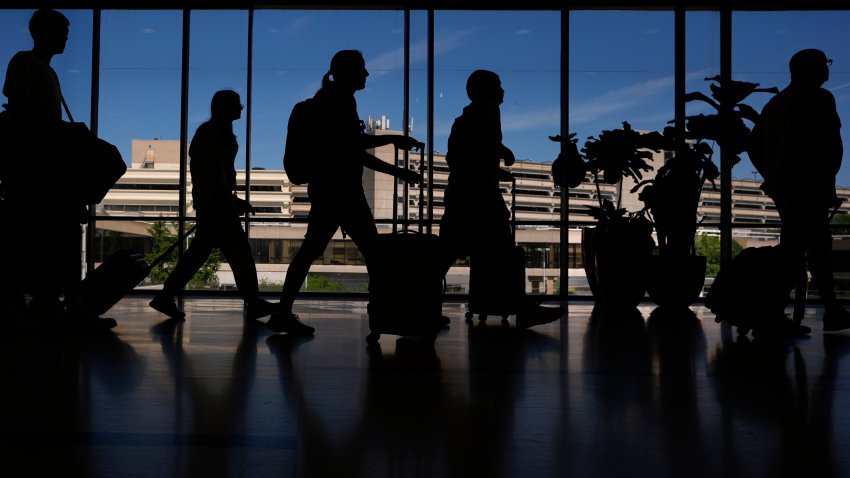 Travelers walk through the Philadelphia International Airport, Wednesday, July 3, 2024, in Philadelphia.