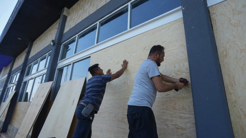 Furniture store employees board up windows for protection ahead of Hurricane Beryl’s expected arrival, in Playa del Carmen, Mexico, Wednesday, July 3, 2024.