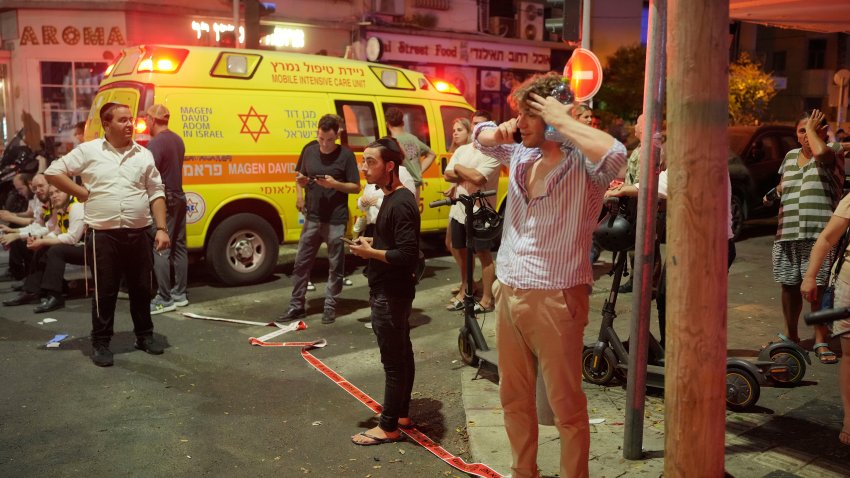 People gather at the scene of a deadly explosion in Tel Aviv