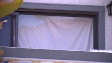 This photo shows the smashed sliding glass door to Connie Dadkhah's second story balcony.