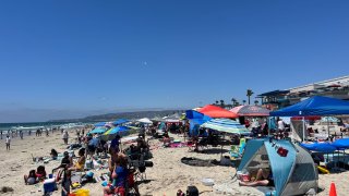 Crowds pack Mission Beach in San Diego on the Fourth of July, July 4, 2024.