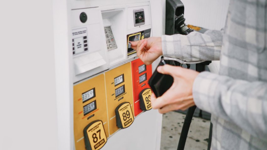 Close-up of unrecognizable white male man purchasing gas at pump