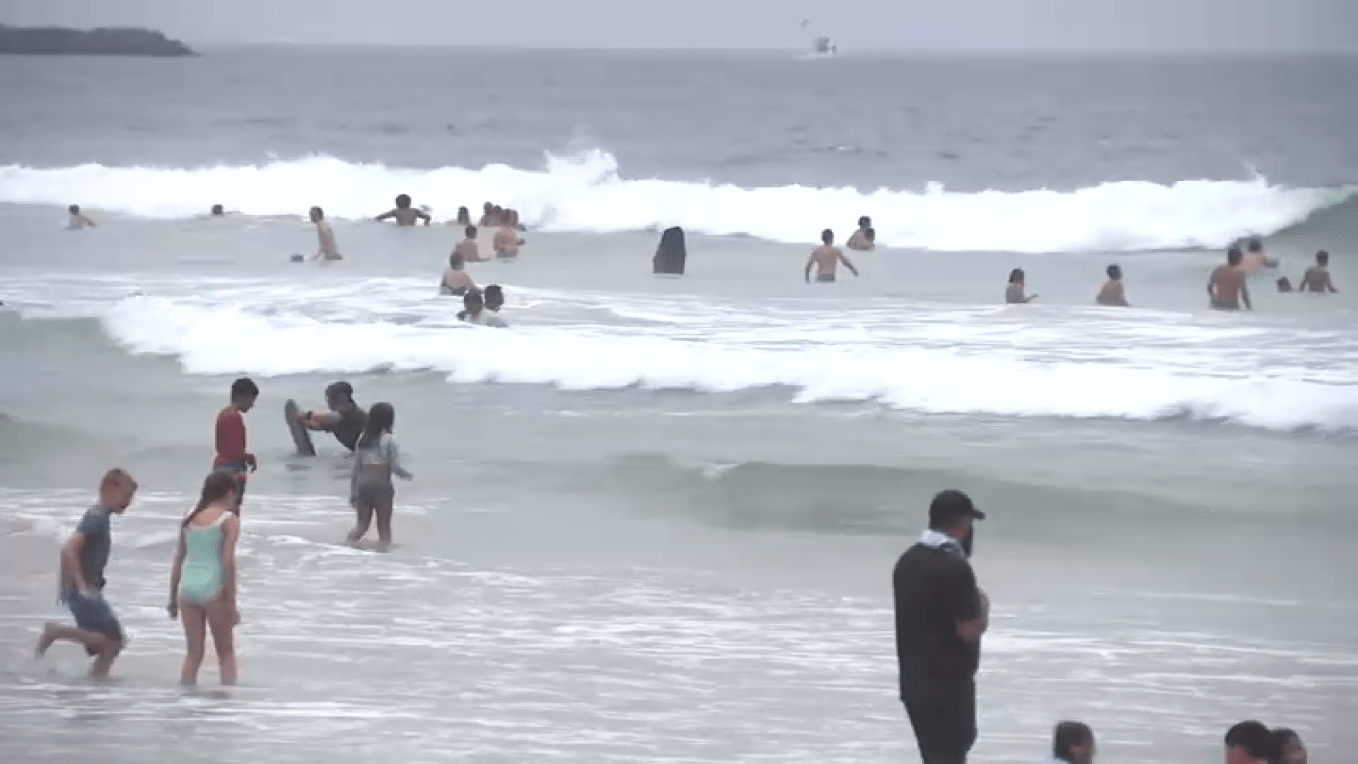 People swimming at Mission Beach on July 4, 2024.