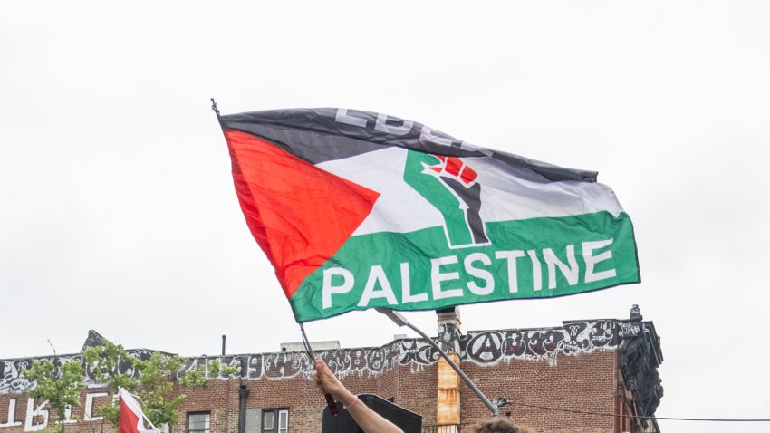 Someone holds a Palestinian flag