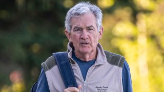 Jerome Powell, chairman of the U.S. Federal Reserve, right, walks the grounds at the Jackson Hole economic symposium in Moran, Wyoming, US, on Thursday, Aug. 24, 2023.