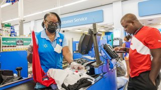 Augusta, Georgia, Walmart Supercenter, cashier and customer in checkout line.