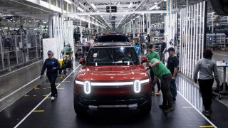 Workers assemble second-generation R1 vehicles at electric auto maker Rivian’s manufacturing facility in Normal, Illinois, U.S. June 21, 2024. 
