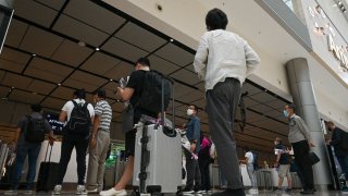 Passengers at an immigration checkpoint at Singapore Changi Airport.