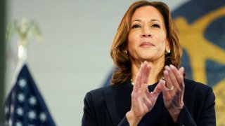 U.S. Vice President and Democratic presidential candidate Kamala Harris applauds during a campaign event with her vice presidential running mate Minnesota Governor Tim Walz at the United Auto Workers (UAW) Local 900 in Wayne, Michigan, U.S., August 8, 2024. 