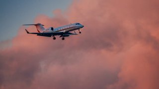 A Gulfstream G-IV private jet flies past clouds at sunset on approach to Washington’s Reagan National Airport on June 12, 2024, in Arlington, Virginia.