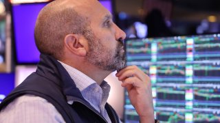 Traders work on the floor of the New York Stock Exchange during morning trading on August 20, 2024 in New York City.