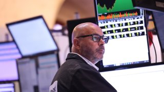 Traders work on the floor of the New York Stock Exchange during morning trading on August 20, 2024 in New York City.