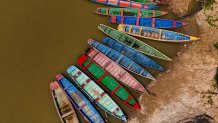 Boats sit on the bank of the Acre River, the main water source for the city of Rio Branco, which is facing water shortages amid a drought in Acre state, Brazil, Friday, Aug. 2, 2024. (AP Photo/Marcos Vicentti)