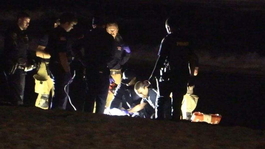 A shot of the first-responders trying to resuscitate the man who drowned Saturday night in Pacific Beach.