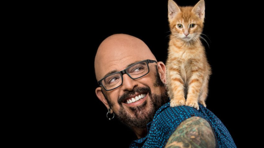 Jackson Galaxy smiles at orange kitten on his shoulder