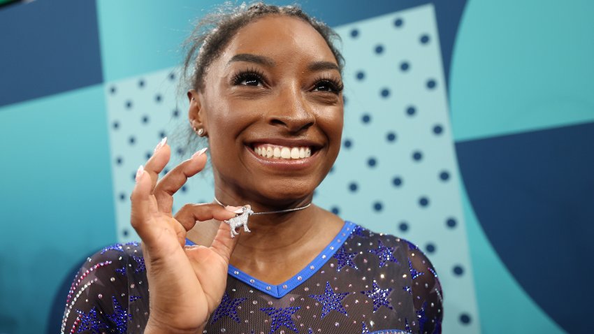 PARIS, FRANCE – AUGUST 01: Gold medalist Simone Biles of Team United States poses with a necklace in the likeness of a goat after competing in the Artistic Gymnastics Women’s All-Around Final on day six of the Olympic Games Paris 2024 at Bercy Arena on August 01, 2024 in Paris, France. (Photo by Jamie Squire/Getty Images)