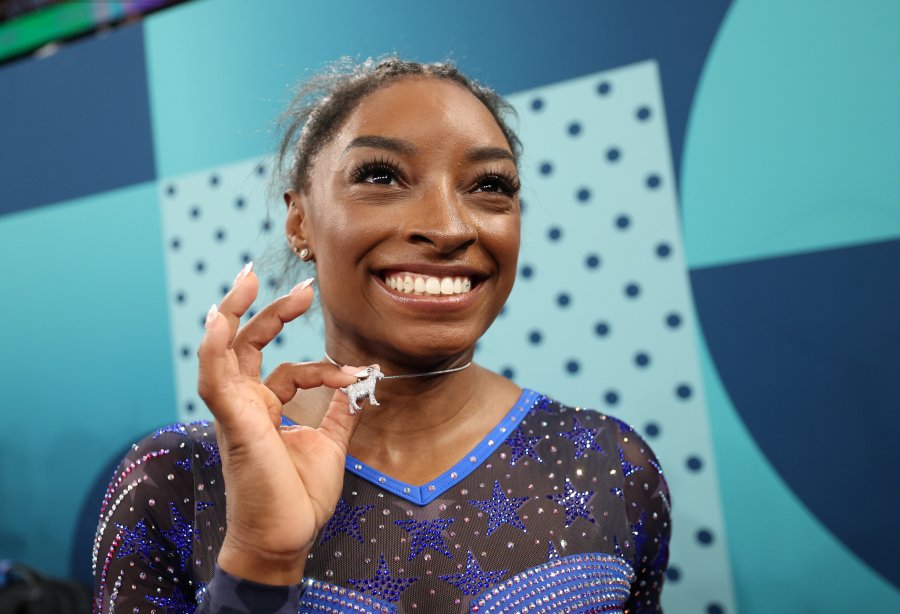 Biles shows off a bejeweled goat necklace