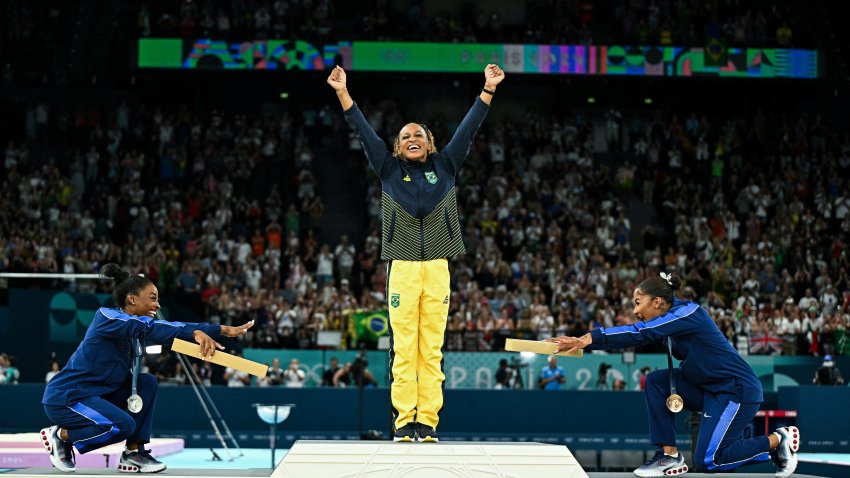 TOPSHOT – (LtoR) US’ Simone Biles (silver), Brazil’s Rebeca Andrade (gold) and US’ Jordan Chiles (bronze) pose during the podium ceremony for the artistic gymnastics women’s floor exercise event of the Paris 2024 Olympic Games at the Bercy Arena in Paris, on August 5, 2024. (Photo by Gabriel BOUYS / AFP) (Photo by GABRIEL BOUYS/AFP via Getty Images)