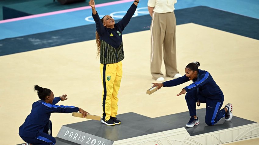 (LtoR) US’ Simone Biles (silver), Brazil’s Rebeca Andrade (gold) and US’ Jordan Chiles (bronze) pose during the podium ceremony for the artistic gymnastics women’s floor exercise event of the Paris 2024 Olympic Games at the Bercy Arena in Paris, on August 5, 2024. (Photo by Paul ELLIS / AFP) (Photo by PAUL ELLIS/AFP via Getty Images)