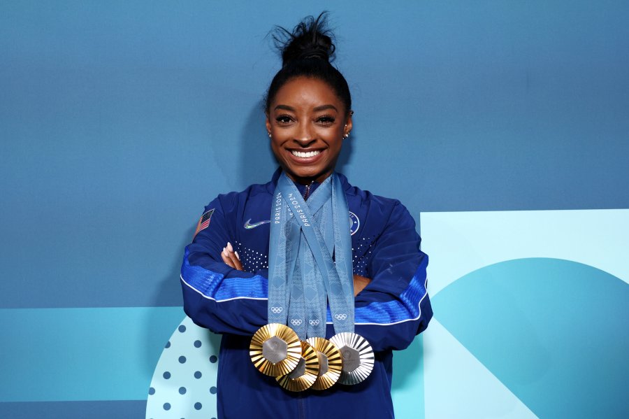 Biles poses with her three gold medals and one silver medal