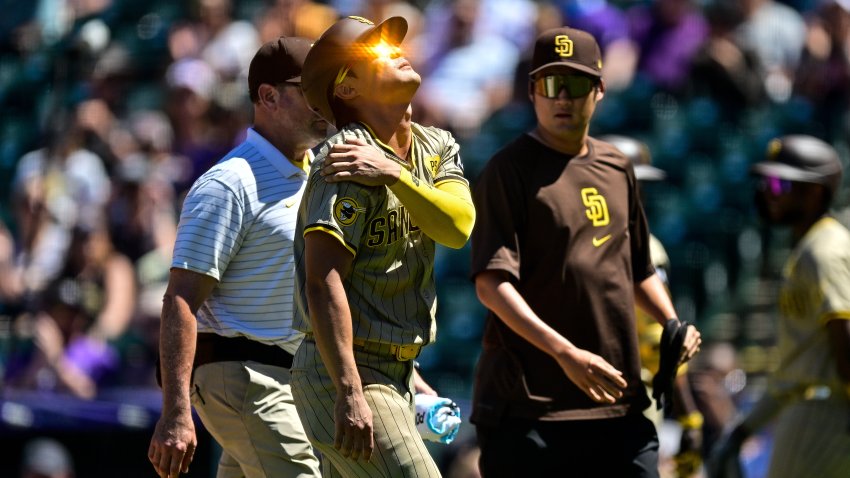 DENVER, COLORADO – AUGUST 18: Ha-Seong Kim #7 of the San Diego Padres comes out of the game with an apparent upper body injury after sliding to avoid a pickoff attempt at first base in the third inning against the Colorado Rockies at Coors Field on August 18, 2024 in Denver, Colorado. (Photo by Dustin Bradford/Getty Images)