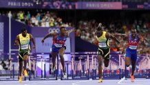 PARIS, FRANCE - AUGUST 08: Grant Holloway of Team United States (2nd L) wins the gold medal ahead of bronze medalist Rasheed Broadbell (C) of Team Jamaica and silver medal Daniel Roberts of Team United States cross the finish line in Men's 110m Hurdles  on day thirteen of the Olympic Games Paris 2024 at Stade de France on August 08, 2024 in Paris, France. (Photo by Hannah Peters/Getty Images)