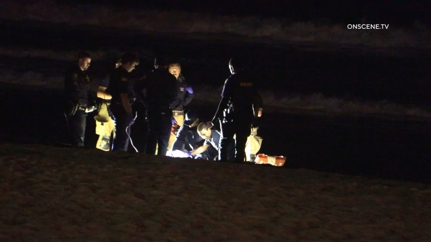 A shot of the first-responders trying to resuscitate the man who drowned Saturday night in Pacific Beach.