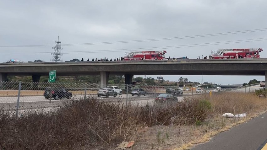 Police officers and firefighters on an overpass above state Route 52 westbound on Friday morning.