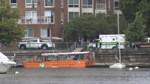 A duck boat docks in Cambridge, Massachusetts, during the rescue of a toddler and his father from the Charles River on Monday, Aug. 19, 2024.