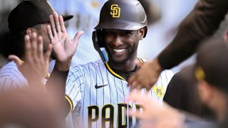 SAN DIEGO, CALIFORNIA – AUGUST 19: Jurickson Profar #10 of the San Diego Padres is congratulated in the dugout after scoring a run against the Minnesota Twins during the first inning at Petco Park on August 19, 2024 in San Diego, California. (Photo by Orlando Ramirez/Getty Images)