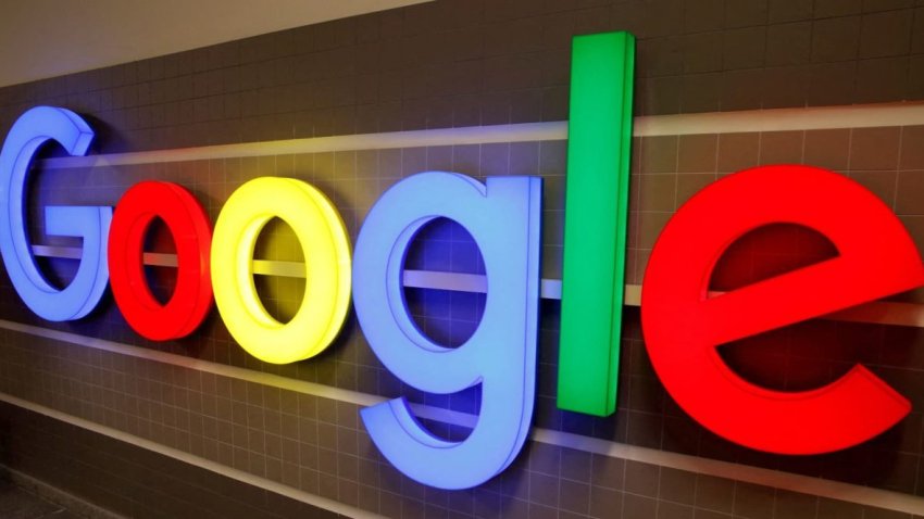 An illuminated Google logo is seen inside an office building in Zurich, Switzerland.