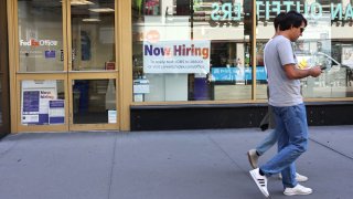 A “Now Hiring” sign is seen at a FedEx location on Broadway on June 07, 2024 in New York City.