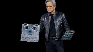 Jensen Huang, co-founder and CEO of Nvidia, displays the new Blackwell GPU chip during the Nvidia GPU Technology Conference in San Jose, California, on March 18, 2024.