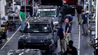 Workers assemble second-generation R1 vehicles at electric auto maker Rivian’s manufacturing facility in Normal, Illinois, U.S. June 21, 2024. 