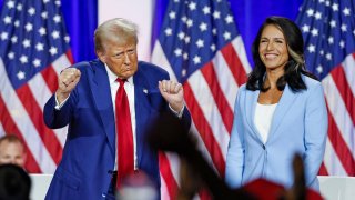 Former US President and Republican presidential candidate Donald Trump (L) dances as he leaves the stage after speaking alongside former US Representative Tulsi Gabbard during a town hall meeting in La Crosse, Wisconsin, on August 29, 2024. 