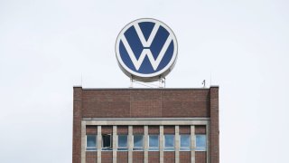 The white and blue VW logo stands on the roof of the brand tower on the grounds of the VW plant in Wolfsburg.