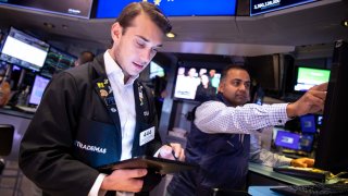 Traders work on the floor of the New York Stock Exchange.