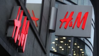 The logo of Swedish clothing retailer H&M hangs over one of its stores on March 28, 2018 in Berlin, Germany.