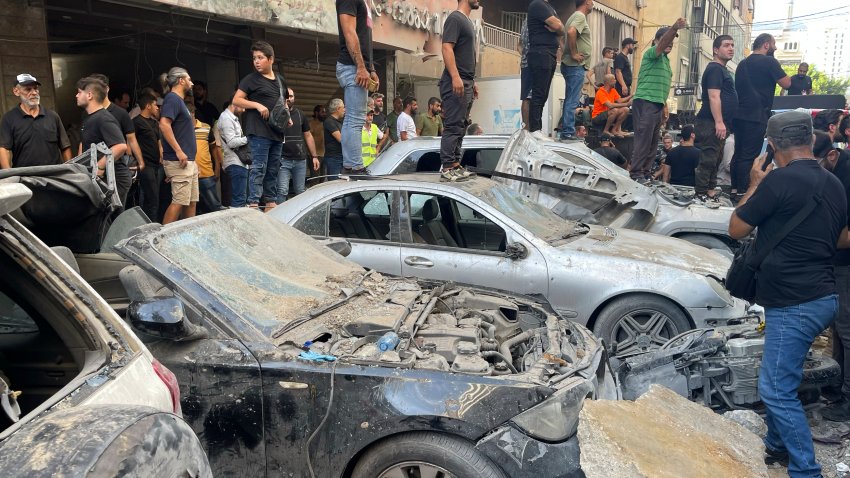 People gather at the scene of an Israeli missile strike in the southern suburbs of Beirut, Friday, Sept. 20, 2024.