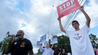 Jesse Motte, right, protests the planned execution of Freddie Eugene Owens