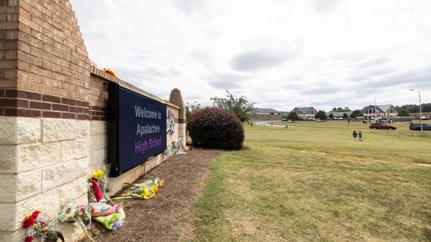 File. The entrance sign of Apalachee High School adorned with flowers from visitors on September 5, 2024 in Winder, Georgia. Two students and two teachers were shot and killed at the school on September 4, and a 14-year-old suspect, who is a student at the school, is in custody.