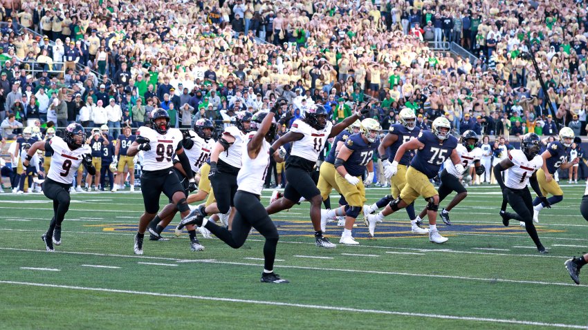 SOUTH BEND, IN – SEPTEMBER 07: Northern Illinois Huskies defensive end Pierce Oppong (99) and his teammates react to the upset victory against the Notre Dame Fighting Irish on September 7, 2024, at Notre Dame Stadium in South Bend, Indiana. (Photo by Brian Spurlock/Icon Sportswire via Getty Images)