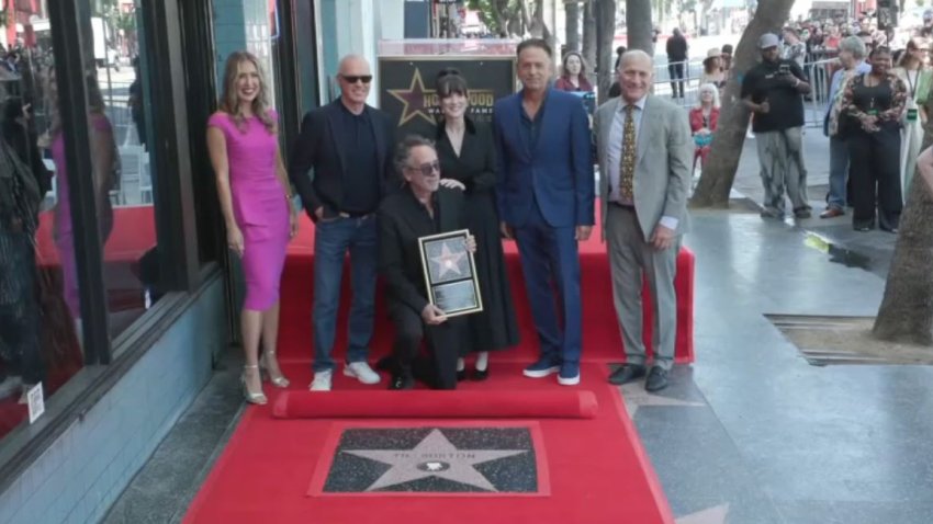 Director Tim Burton poses next to his Hollywood Walk of Fame star Tuesday Sept. 3, 2024.