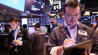 Traders work on the floor of the New York Stock Exchange during morning trading on Oct. 8, 2024.