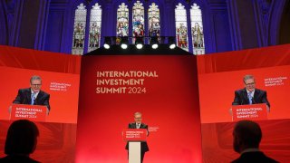 Britain’s Prime Minister Keir Starmer delivers a speech on stage during the International Investment Summit, held at The Guildhall, in central London, on October 14, 2024.