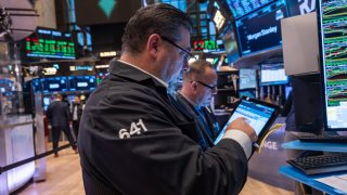 NEW YORK, NEW YORK – OCTOBER 16: Traders and others work on the New York Stock Exchange (NYSE) floor in New York City. 